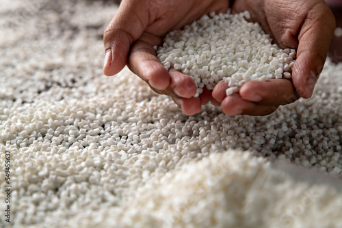 Close-up of plastic polymer granules, hand hold Polymer pellet, polymer plastic, compound polymer, Technology product of plastic chemical, green polymer, resin from petrochemical,