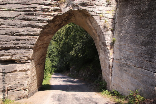 The famous rock formation with a carved Gothic arch known as Pekarova brana Gate near Lazany, Czech republic photo