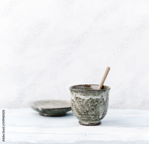 Traditional, handcrafted ceramic on bright wooden background. Soft focus. Copy space. 