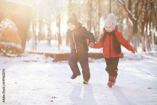 Children in winter park play © alexkich