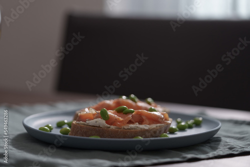 Bruschettas with cream cheese and salmon on dining table