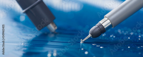 Measuring electronic signal using oscilloscope on the PCB. Electronics repair and digital technology.