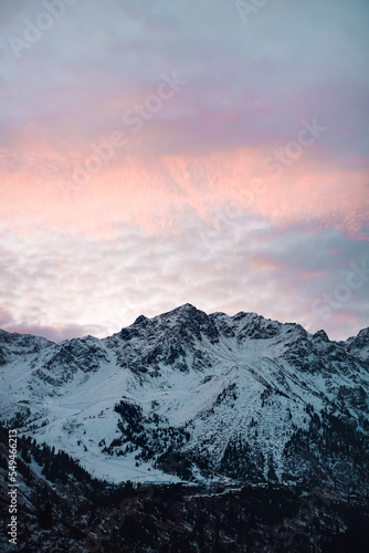 beautiful snow-capped big mountains at dawn with scarlet color clouds © Gregory
