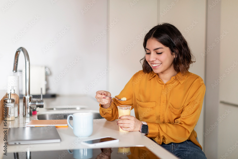 Young Arab Woman Eating Pudding And Drinking Coffee For Breakfast At Home Young Arab Woman Eating Pudding And Drinking Coffee For Breakfast At Home