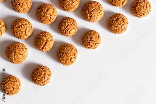 homemade amaretti cookies with cracks on a light background pattern copy space