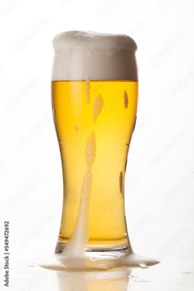 Glass of light beer isolated on white background, foam, bubbles, close-up Glass of light beer isolated on white background, foam, bubbles, close-up