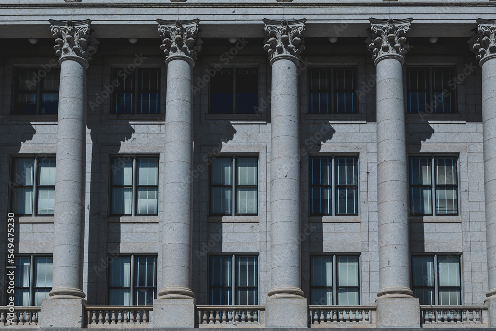 The architecture of buildings windows, stucco molding, and columns on a sunny day in the USA. High-quality photo