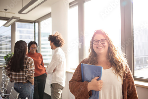 Young caucasian girl is looking at the camera in the office
