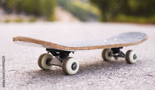 Skate stands on the asphalt road.