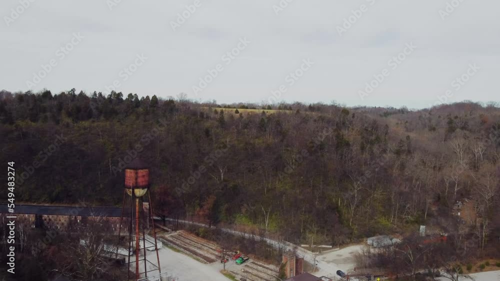 Starting from areal view of an old abandoned factory, continuing towards hills and winter forest in rural Kentucky fields and neighborhoods. Starting from areal view of an old abandoned factory, continuing towards hills and winter forest in rural Kentucky fields and neighborhoods.