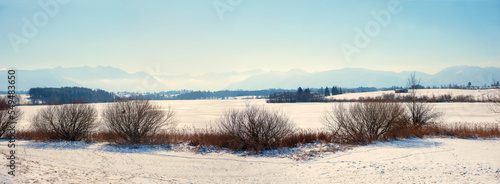 frozen lake Riegsee winter landscape and alps view bavaria photo