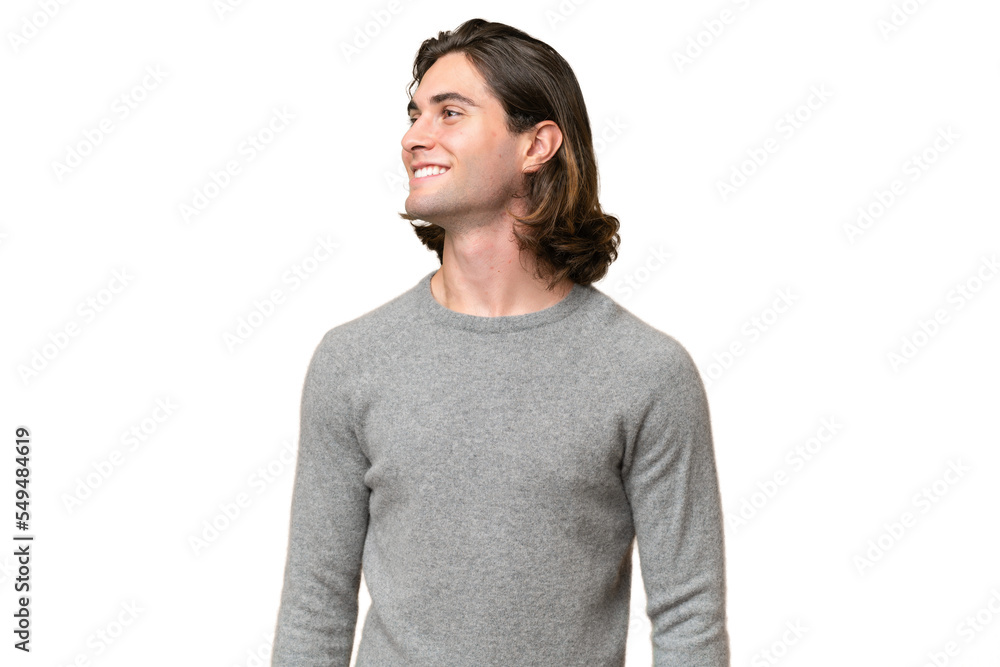 Young caucasian man isolated on green chroma background looking side Young caucasian man isolated on green chroma background looking side