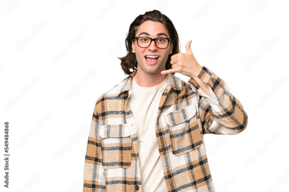 Young caucasian man isolated on green chroma background making phone gesture. Call me back sign Young caucasian man isolated on green chroma background making phone gesture. Call me back sign