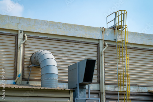 Several white ventilation vents are located next to the building.