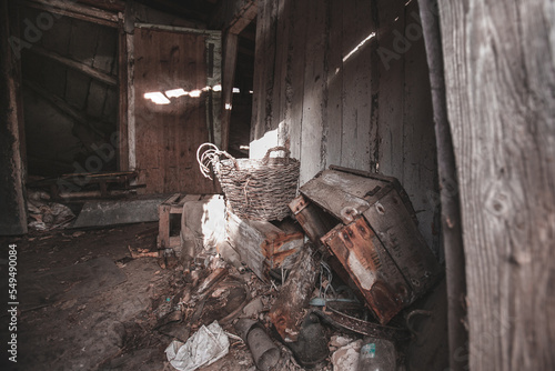 Dark room inside an abandoned rural house, a dump of household items, a village near the city of Pripyat, Chernobyl region, exclusion zone, Ukraine, gloomy November
