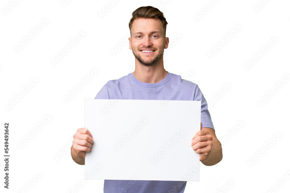 Young blonde caucasian man over isolated background holding an empty placard with happy expression Young blonde caucasian man over isolated background holding an empty placard with happy expression