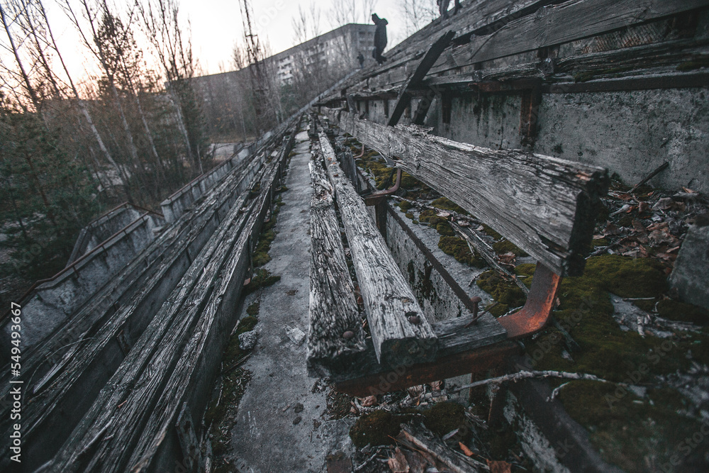 Abandoned stadium in the city of Pripyat, rotten benches of spectators, Chernobyl region, exclusion zone, Ukraine Abandoned stadium in the city of Pripyat, rotten benches of spectators, Chernobyl region, exclusion zone, Ukraine