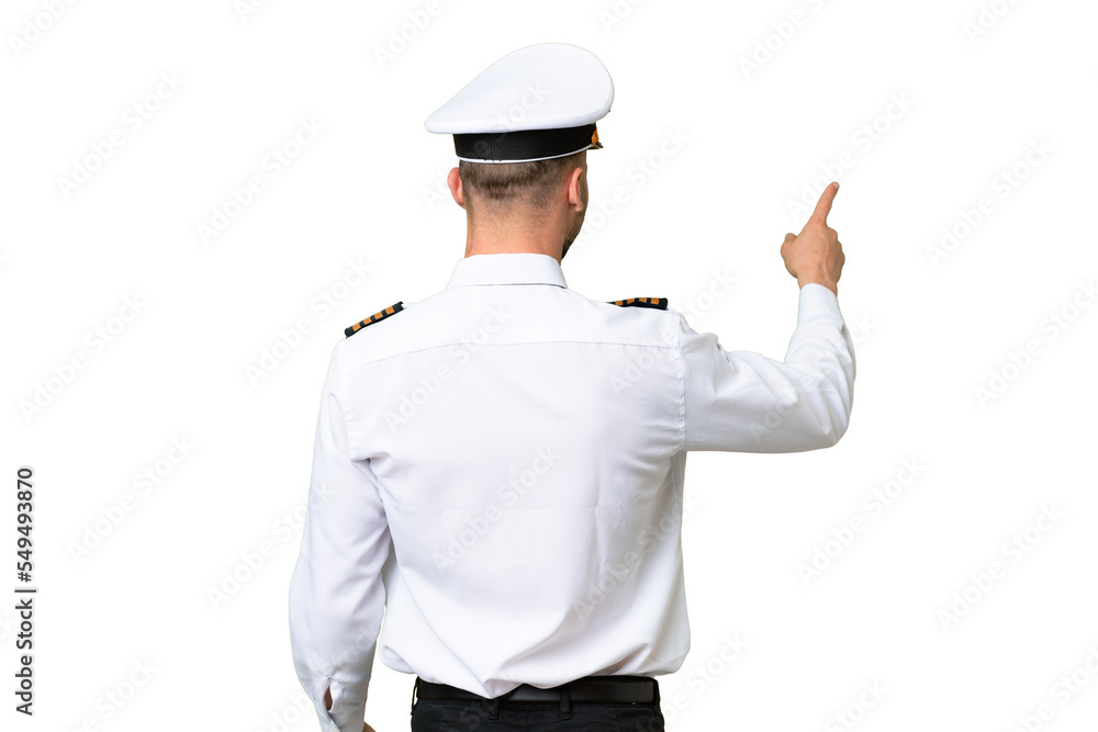 Airplane pilot man over isolated background pointing back with the index finger Airplane pilot man over isolated background pointing back with the index finger