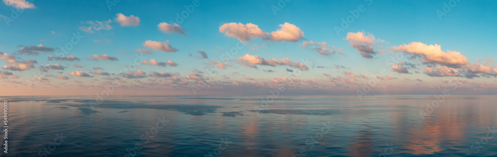Dramatic Colorful Sunrise Sky over Mediterranean Sea. Puffy clouds. Cloudscape Nature Background. Panorama