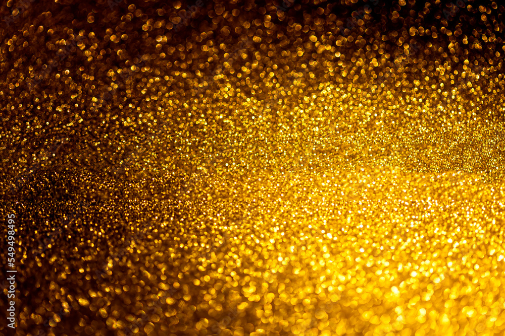 Abstract glitter lights background. De focused.