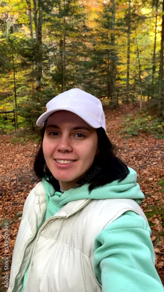 woman standing in autumn forest enjoying that fall season woman standing in autumn forest enjoying that fall season