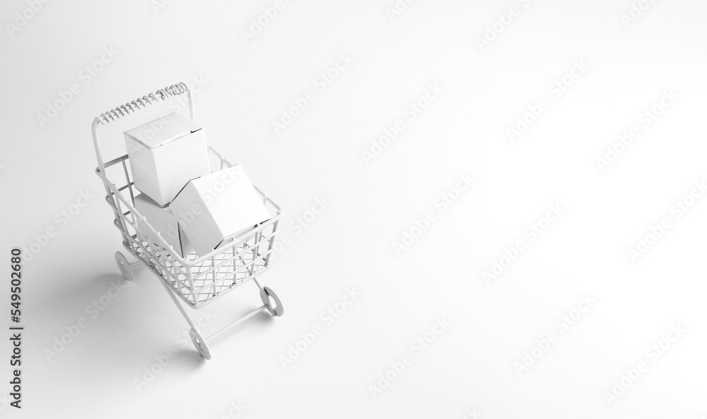 Shopping online business, e-commerce, delivery, purchasing power concepts. White parcel boxes in shopping trolley cart supermarket isolated on white background with copy space, minimal style.