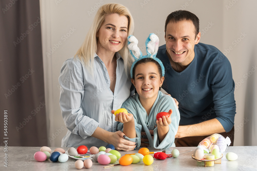 Nice lovely sweet attractive beautiful friendly cheerful positive family paining Easter eggs together.