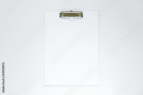 white clipboard on a white table. empty space for text