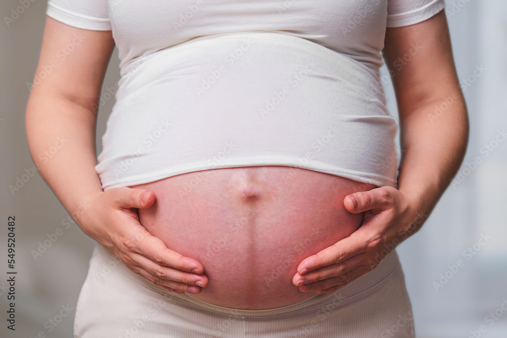 Dark stripe on the belly of a pregnant woman, home living room Dark stripe on the belly of a pregnant woman, home living room