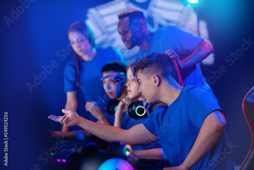 Multi cultural team gamers caucasian  african  asian of professional online video game players discuss strategy plan. Concept tournament cyber esport