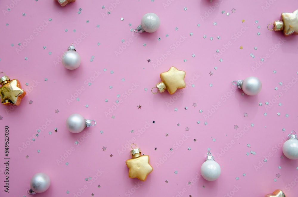 Christmas composition. A pattern of christmas balls and stars decorations on pink background. Flat lay, top view New year decor.