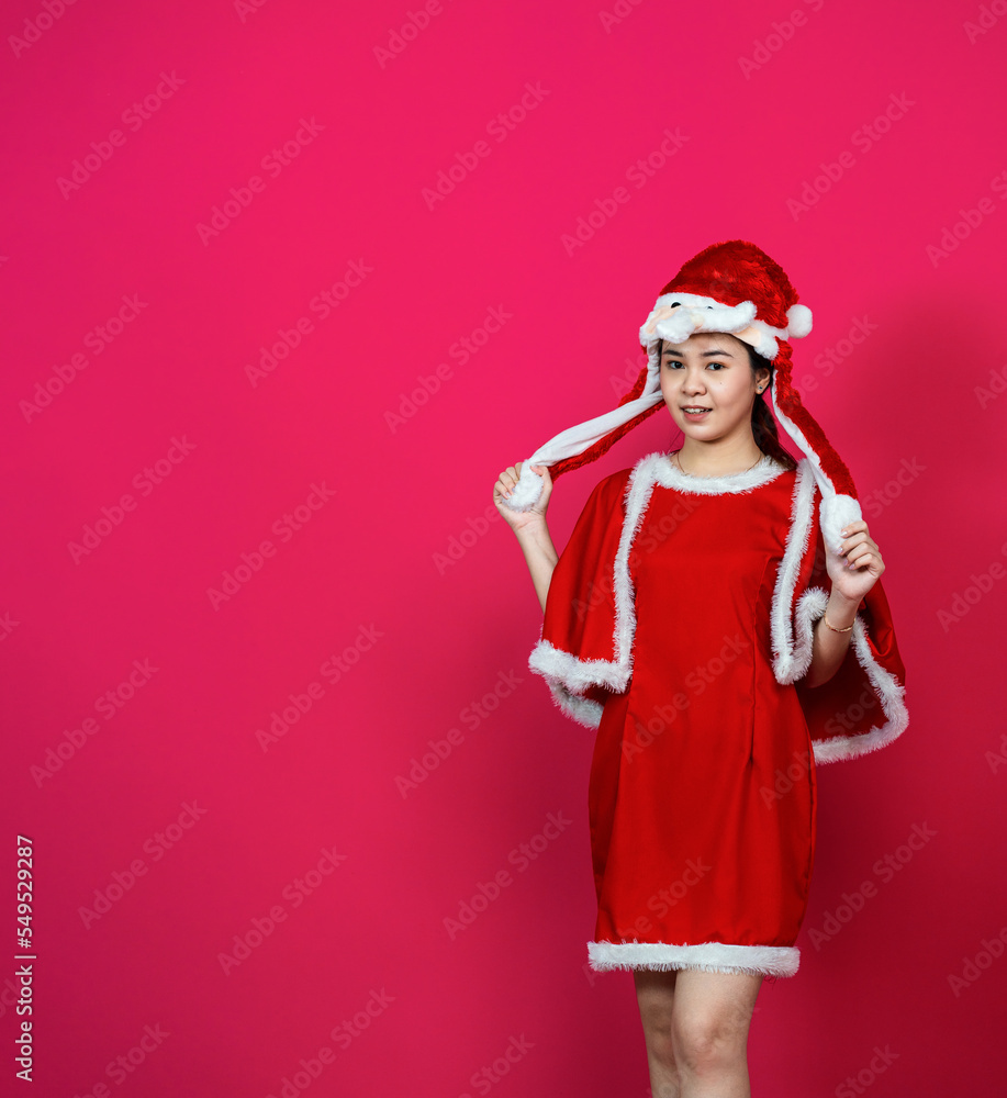 An Asian Young Woman With Blank Copyspace on Her Side With a Red Background An Asian Young Woman With Blank Copyspace on Her Side With a Red Background