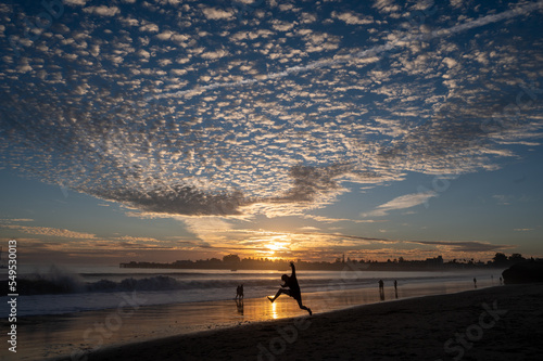 jumping at sunset on the beach