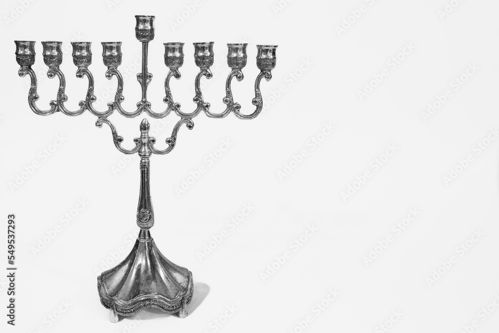 Beautiful silver hanukkah menorah. Ancient ritual candle menorah on a white background Stock