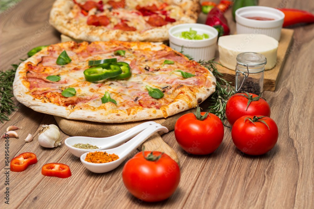 Pepperoni pizza and pizza Capricciosa with mozzarella cheese, ham, tomato sauce, salami, mushroom, pepper, spices and fresh basil