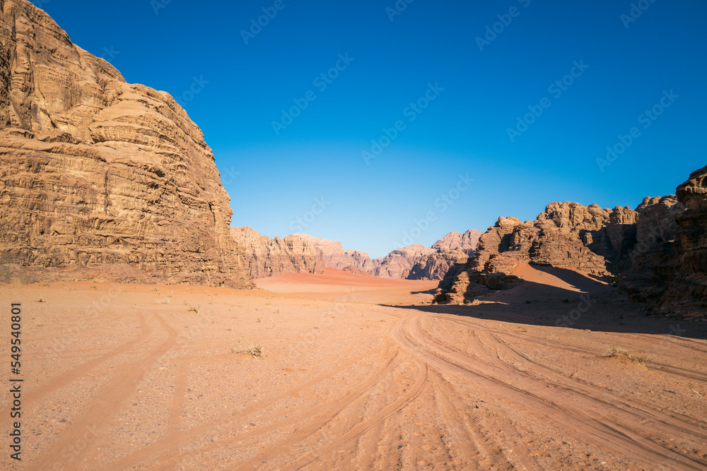 Wadi Rum, Jordan. A beautiful vibrant blue and orange view, Arabian desert, a dystopian martian landscape with unique rock formations and dunes. Backdrop for graphic resource or copy space no people