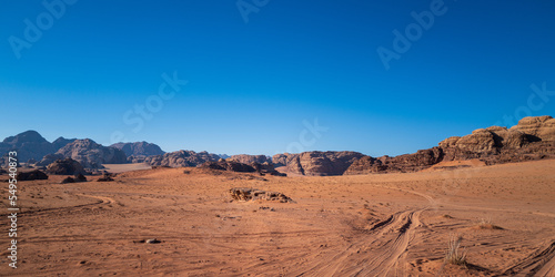 Wadi Rum, Jordan. A beautiful vibrant blue and orange view, Arabian desert, a dystopian martian landscape with unique rock formations and dunes. Backdrop for graphic resource or copy space no people