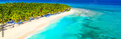 Aerial drone view of beautiful tropical island beach with palms. Vacation background. Banner view
