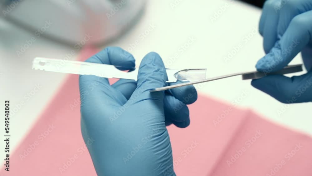 the girl does a manicure, paints her legs, removes varnish. close-up, trims cuticles, covers with base the girl does a manicure, paints her legs, removes varnish. close-up, trims cuticles, covers with base