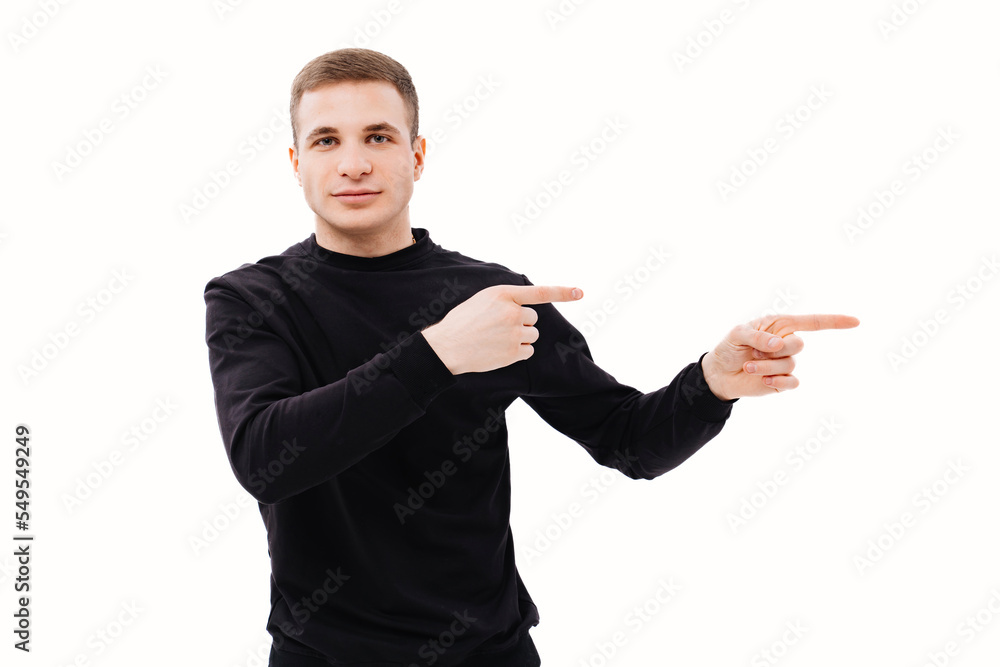 a man in black clothes points his finger at something on a white background. a man in black clothes points his finger at something on a white background.