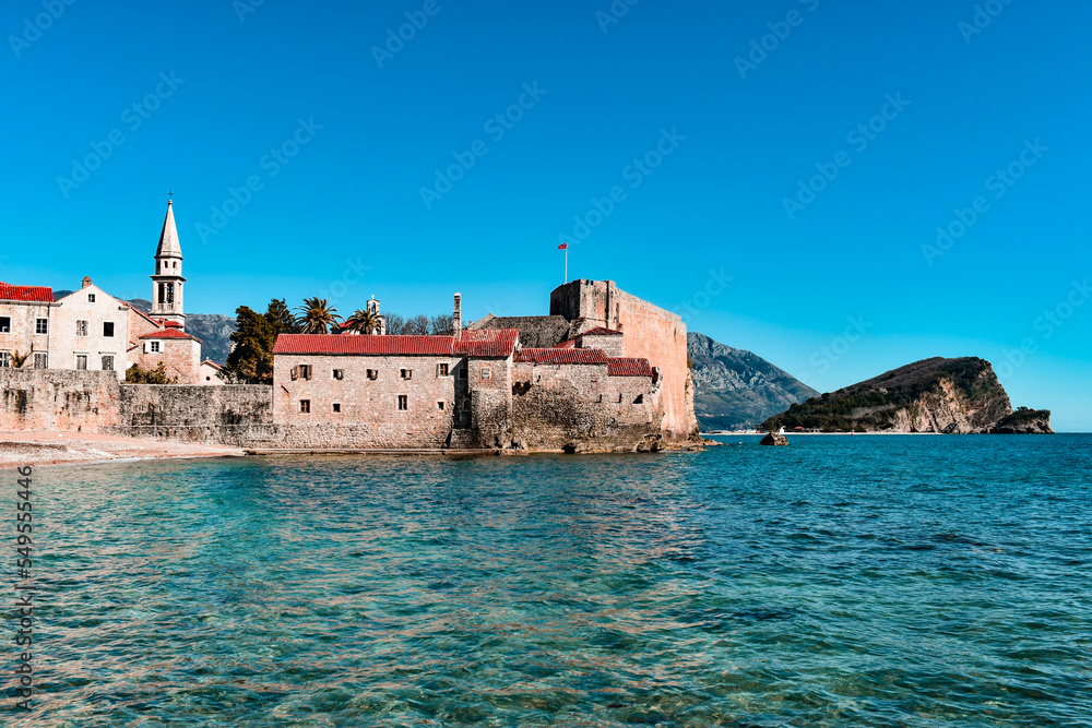 Beautiful coast and the old town of Budva, Montenegro. Adriatic sea water, blue sky