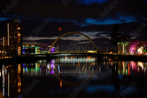 night view of Glasgow city. Bright neon lights of Buildings along the River Clyde