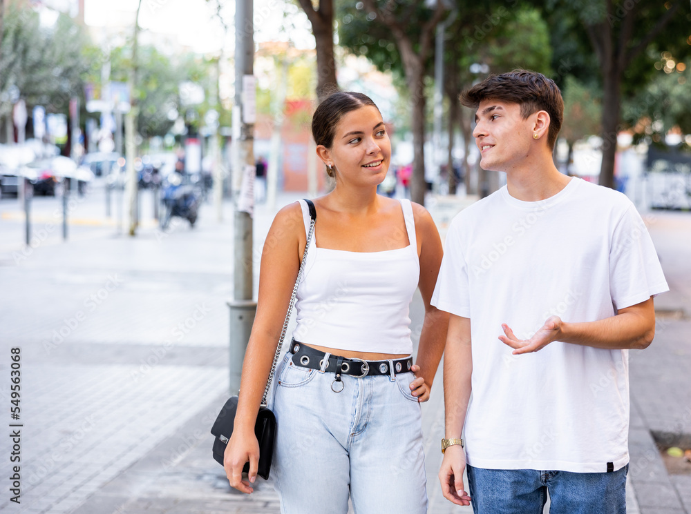 Young couple have a good time together on a summer city street