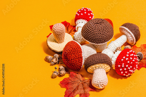 Traditional autumn background. Assorted of different knitted mushrooms, handmade concept