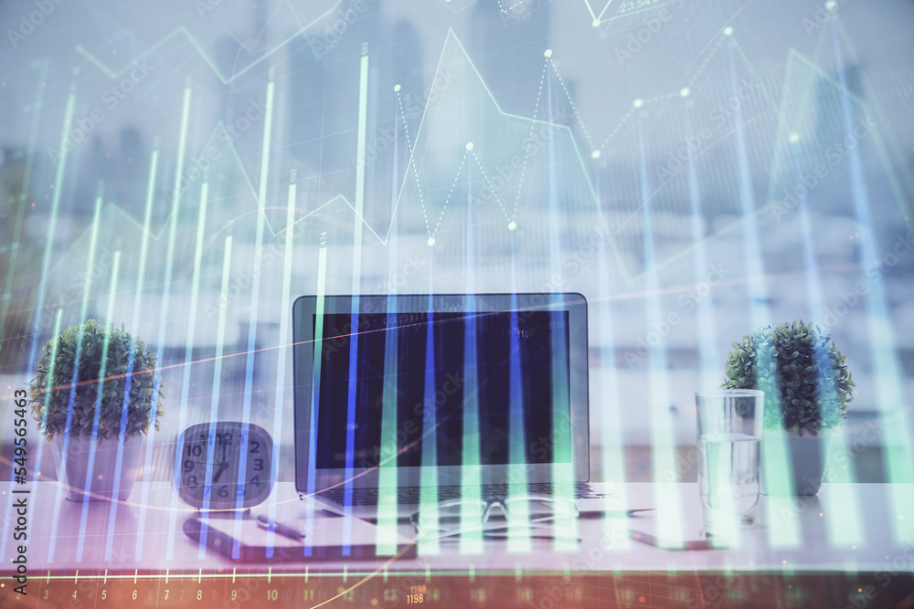 Forex graph hologram on table with computer background. Multi exposure. Concept of financial markets. Forex graph hologram on table with computer background. Multi exposure. Concept of financial markets.