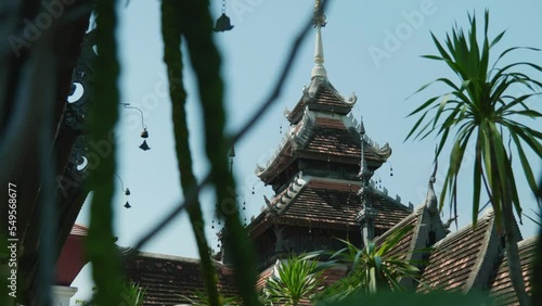 Outdoor view of the famous Wat Hua Wiang Temple in Chiang Mai, Thailand with leaves foreground photo