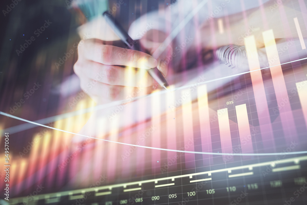 Financial forex graph displayed on hands taking notes background. Concept of research. Double exposure Financial forex graph displayed on hands taking notes background. Concept of research. Double exposure
