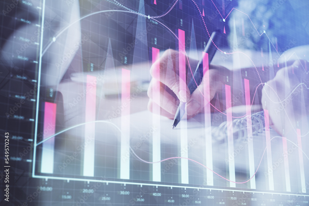 Financial forex graph displayed on hands taking notes background. Concept of research. Multi exposure Financial forex graph displayed on hands taking notes background. Concept of research. Multi exposure