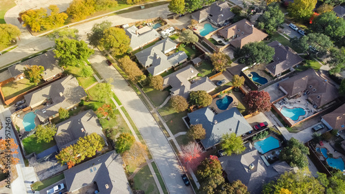 Upscale single family home with swimming pool and colorful fall foliage near Dallas, Texas, America