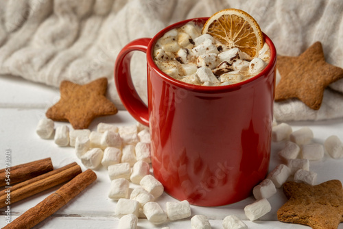 Hot chocolate or cocoa with marshmallows in red cup with cookies. Christmas drink.